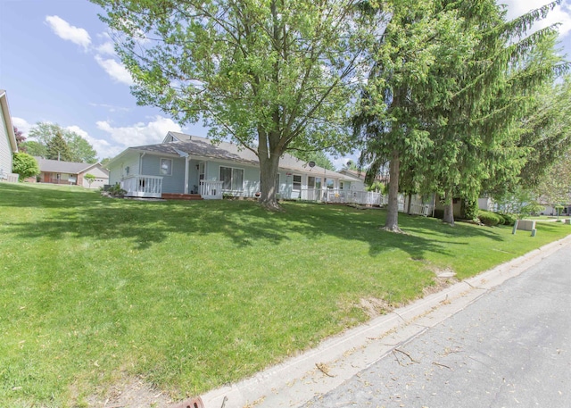 single story home featuring a front lawn and covered porch