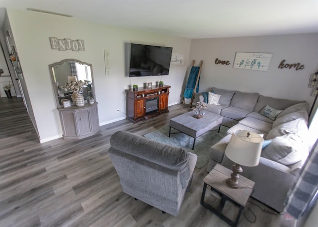 living area featuring wood finished floors and baseboards