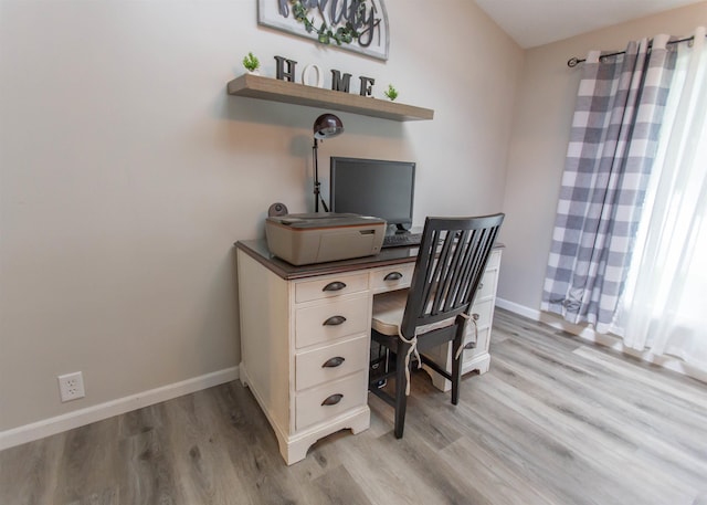 home office featuring light wood-style flooring and baseboards