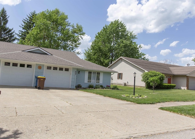 ranch-style home with a garage, a front lawn, concrete driveway, and a shingled roof