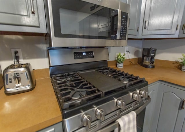 kitchen with appliances with stainless steel finishes and light countertops