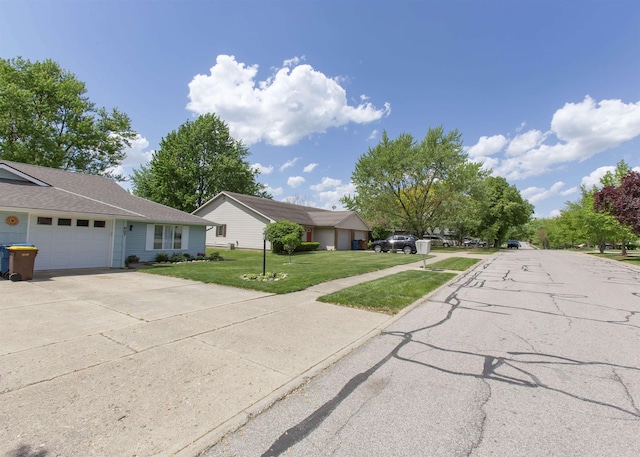 ranch-style house with a front lawn, a garage, and driveway