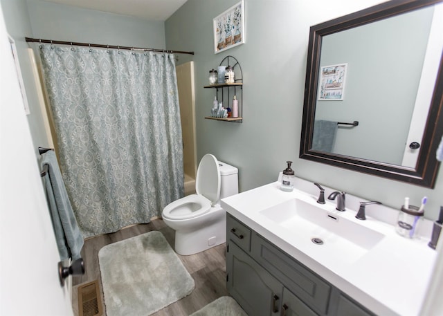 full bath with wood finished floors, toilet, vanity, and shower / bathtub combination with curtain