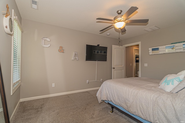 carpeted bedroom with baseboards and a ceiling fan