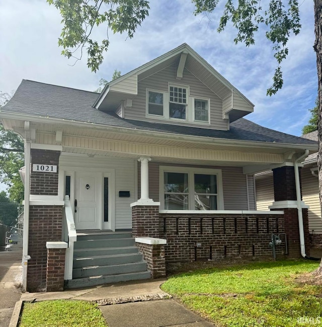 1021 E Blackford Ave, Evansville, IN 47714 - view of front facade with a porch, brick siding, and a shingled roof