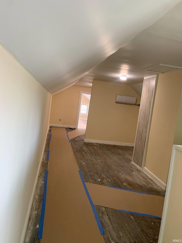 1021 E Blackford Ave, Evansville, IN 47714 - corridor with lofted ceiling, a wall unit AC, wood finished floors, and baseboards