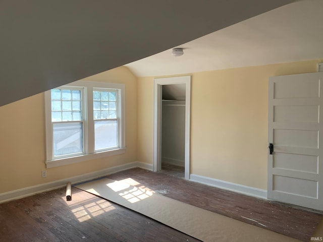 1021 E Blackford Ave, Evansville, IN 47714 - unfurnished bedroom with wood finished floors, baseboards, vaulted ceiling, and a closet