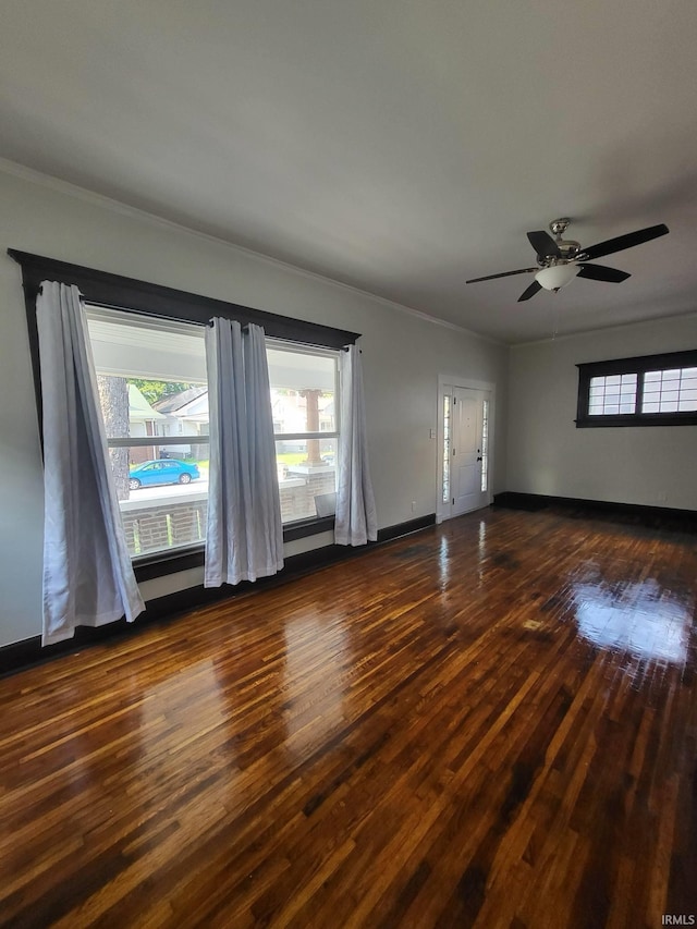 1021 E Blackford Ave, Evansville, IN 47714 - unfurnished room featuring dark wood-style flooring, healthy amount of natural light, crown molding, baseboards, and ceiling fan