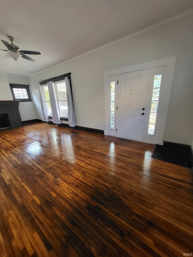 1021 E Blackford Ave, Evansville, IN 47714 - entryway featuring crown molding, plenty of natural light, a ceiling fan, dark wood-type flooring, and a fireplace