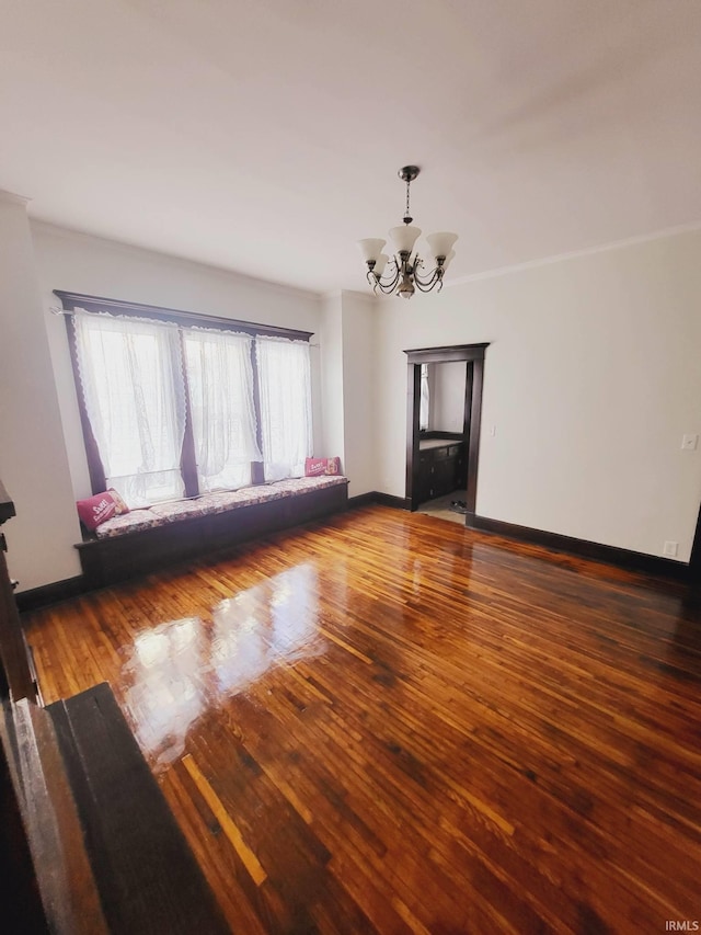 1021 E Blackford Ave, Evansville, IN 47714 - spare room featuring a chandelier, wood finished floors, baseboards, and ornamental molding