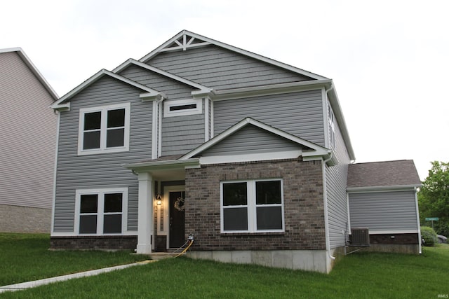 craftsman-style house with a front lawn, central AC, and brick siding