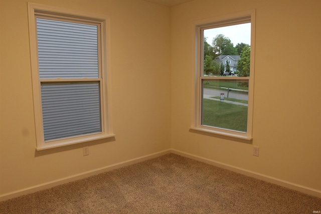 carpeted spare room with baseboards