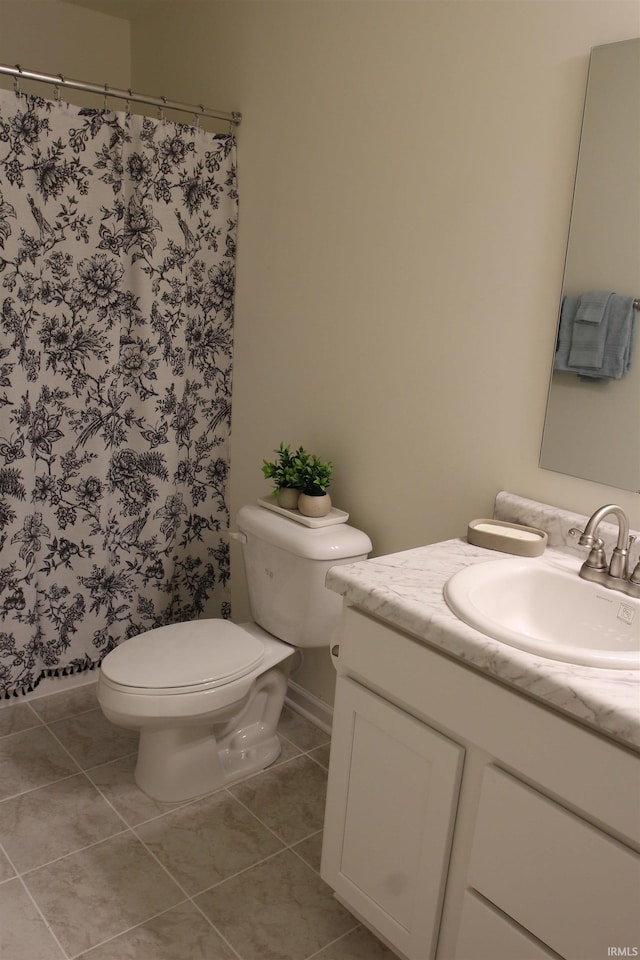 bathroom featuring tile patterned floors, toilet, vanity, and curtained shower
