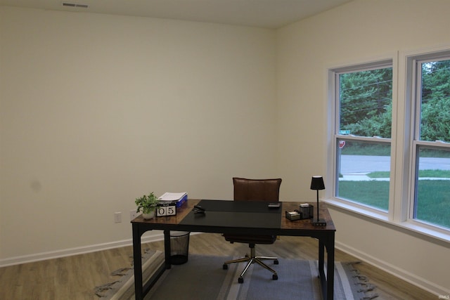 office space with wood finished floors and baseboards