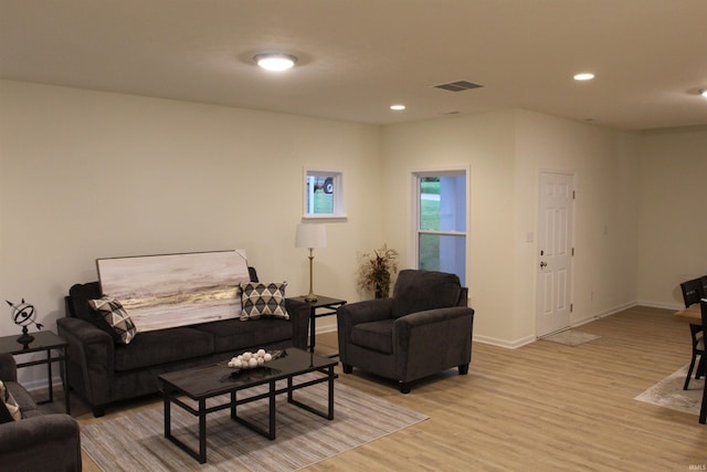 living area with light wood finished floors, recessed lighting, and baseboards