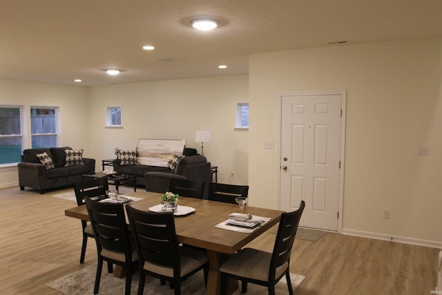 dining space featuring light wood-style flooring, baseboards, and recessed lighting