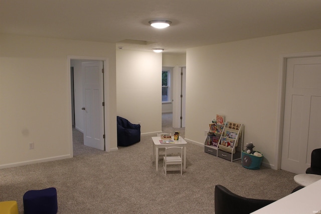 rec room with carpet and baseboards