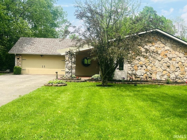 view of front of home with a garage, driveway, a front yard, and stone siding