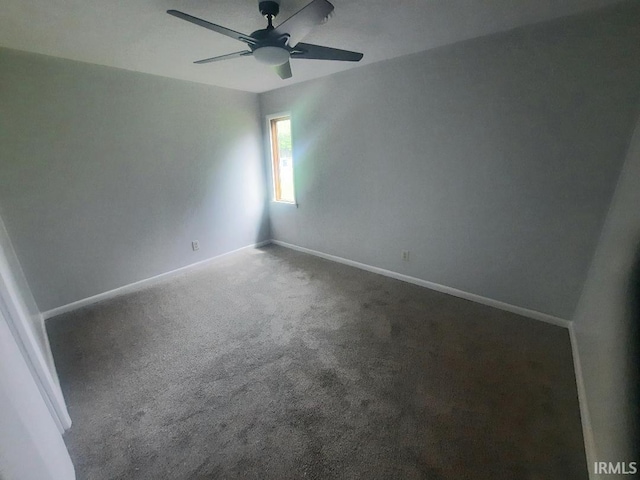 spare room with a ceiling fan, carpet, and baseboards
