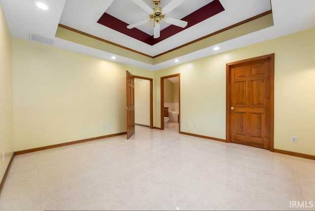 empty room with a raised ceiling, a ceiling fan, recessed lighting, baseboards, and light tile patterned floors