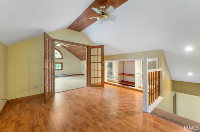 additional living space featuring french doors, a ceiling fan, wood finished floors, baseboard heating, and lofted ceiling