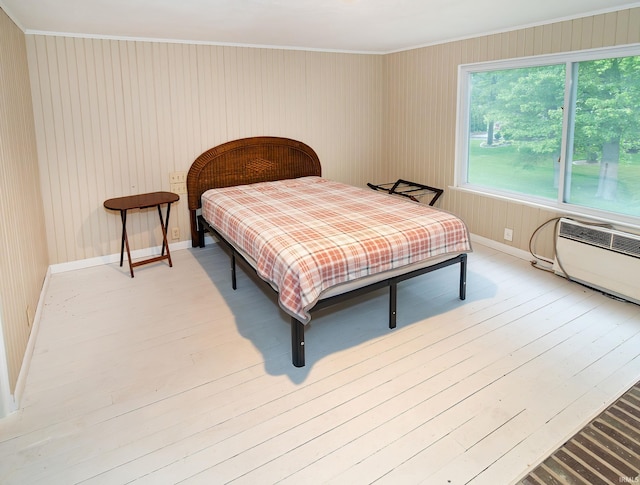 6408 Washington Ave, Evansville, IN 47715 - bedroom featuring ornamental molding, a wall unit AC, light wood-style flooring, and baseboards