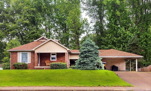 6408 Washington Ave, Evansville, IN 47715 - single story home featuring a porch, concrete driveway, a front lawn, an attached carport, and a shingled roof