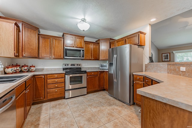 7680 Saint Jordan Cir, Newburgh, IN 47630 - kitchen featuring stainless steel appliances, brown cabinetry, a sink, light countertops, and recessed lighting
