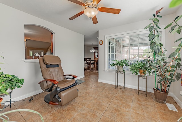 7680 Saint Jordan Cir, Newburgh, IN 47630 - sitting room featuring arched walkways, a ceiling fan, light tile patterned floors, and baseboards