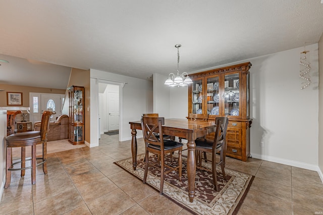 7680 Saint Jordan Cir, Newburgh, IN 47630 - dining space featuring light tile patterned floors, a chandelier, and baseboards