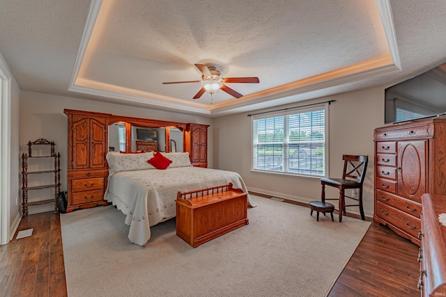 7680 Saint Jordan Cir, Newburgh, IN 47630 - bedroom with a raised ceiling, a textured ceiling, wood finished floors, baseboards, and ceiling fan