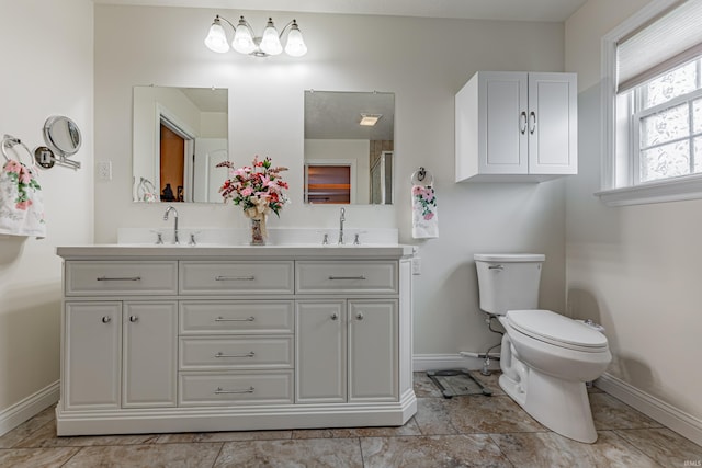 7680 Saint Jordan Cir, Newburgh, IN 47630 - bathroom featuring baseboards, double vanity, and toilet