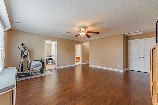7680 Saint Jordan Cir, Newburgh, IN 47630 - exercise area with dark wood-type flooring, a ceiling fan, baseboards, a textured ceiling, and attic access
