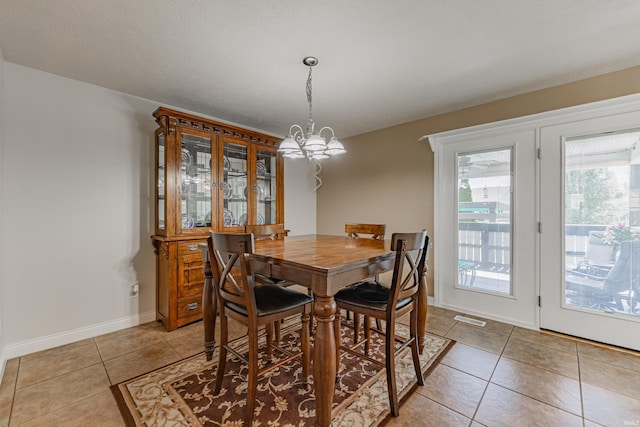 7680 Saint Jordan Cir, Newburgh, IN 47630 - dining room with light tile patterned floors, a chandelier, and baseboards