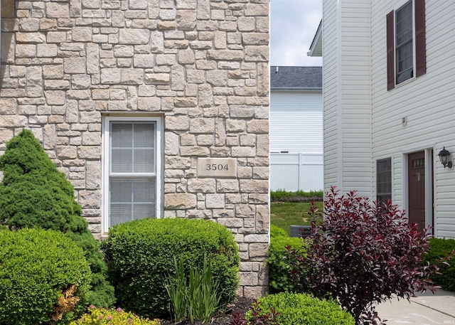 exterior view of stone siding and fence