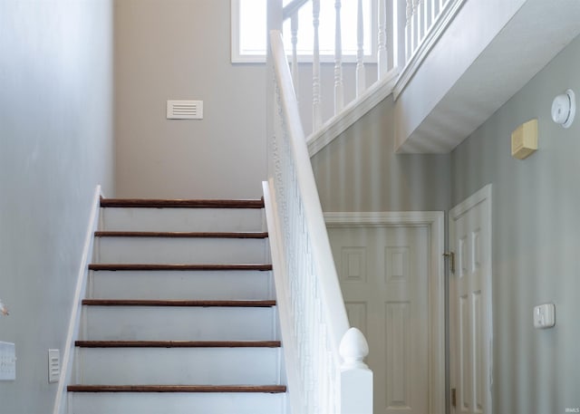 staircase with a towering ceiling