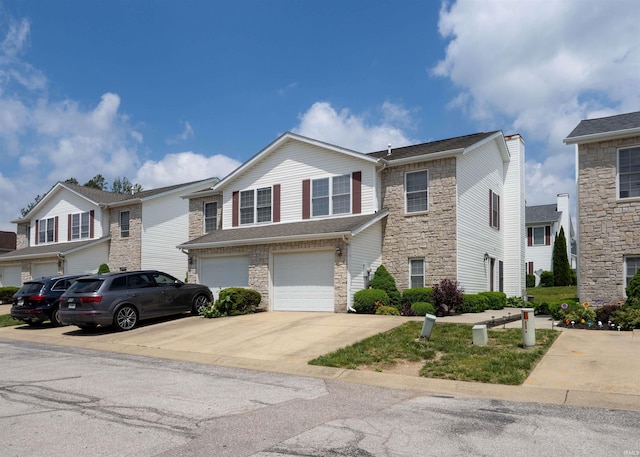 view of front of home featuring stone siding, concrete driveway, and a garage