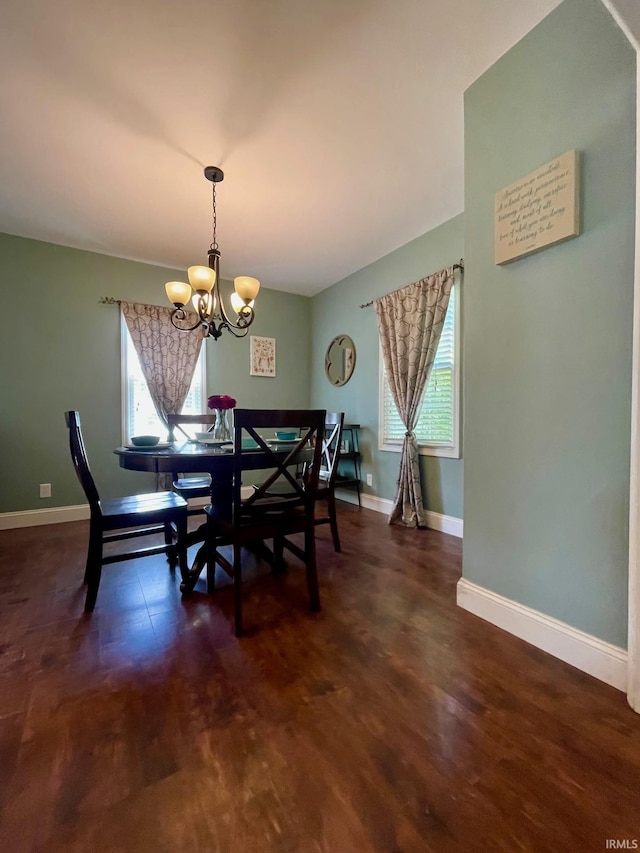 1304 Parkside Dr, Evansville, IN 47714 - dining room featuring a chandelier, baseboards, and dark wood-style flooring