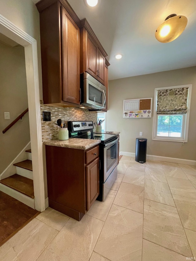 1304 Parkside Dr, Evansville, IN 47714 - kitchen with appliances with stainless steel finishes, tasteful backsplash, baseboards, recessed lighting, and brown cabinets