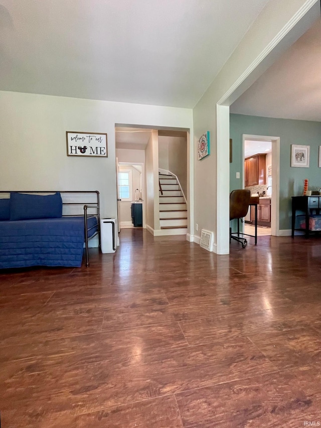 1304 Parkside Dr, Evansville, IN 47714 - living area with stairs, wood finished floors, and baseboards