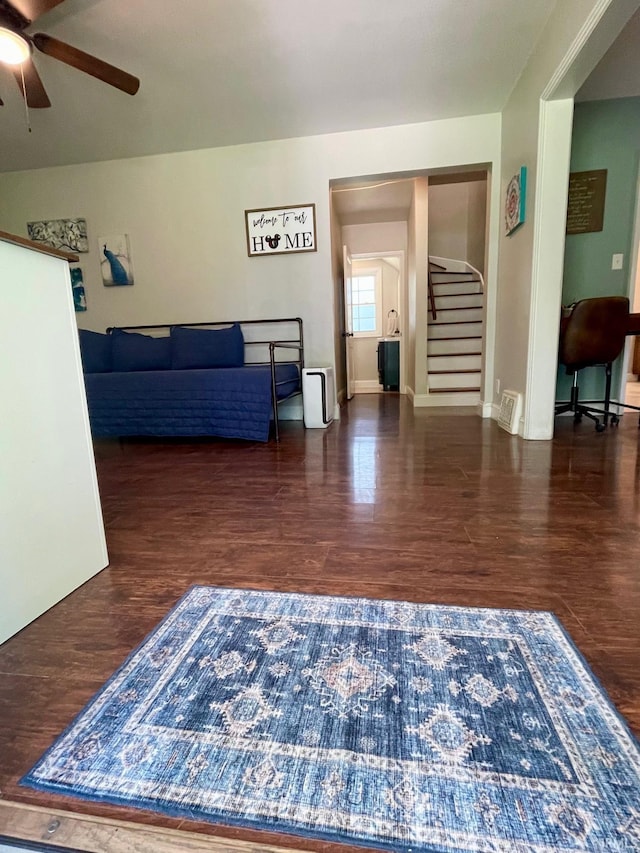 1304 Parkside Dr, Evansville, IN 47714 - living area featuring a ceiling fan, stairs, wood finished floors, and baseboards