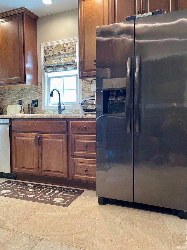 1304 Parkside Dr, Evansville, IN 47714 - kitchen with appliances with stainless steel finishes, decorative backsplash, a sink, and light stone countertops