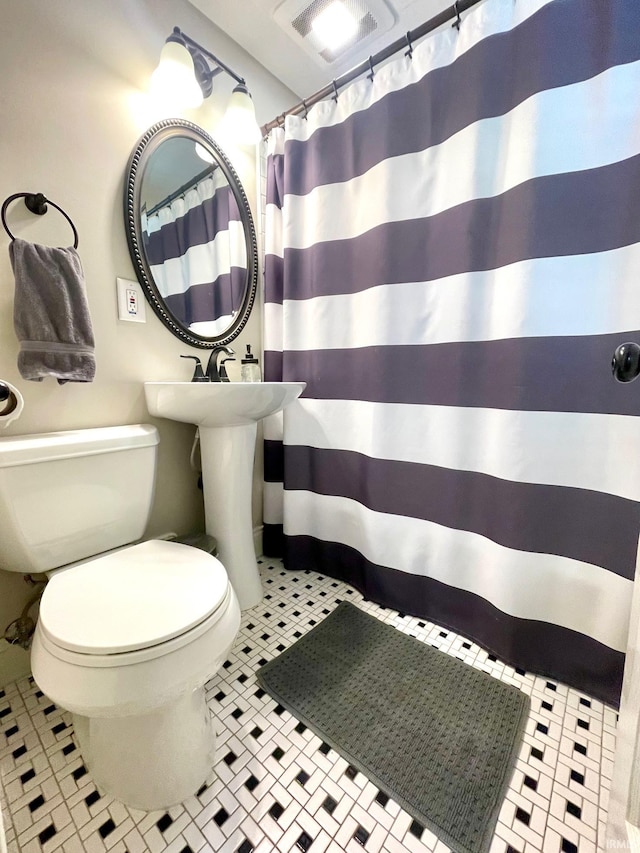 1304 Parkside Dr, Evansville, IN 47714 - bathroom featuring toilet and a shower with curtain