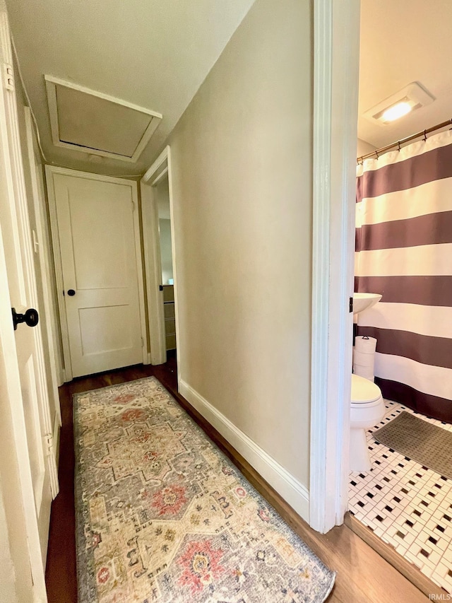 1304 Parkside Dr, Evansville, IN 47714 - hallway with attic access, wood finished floors, and baseboards