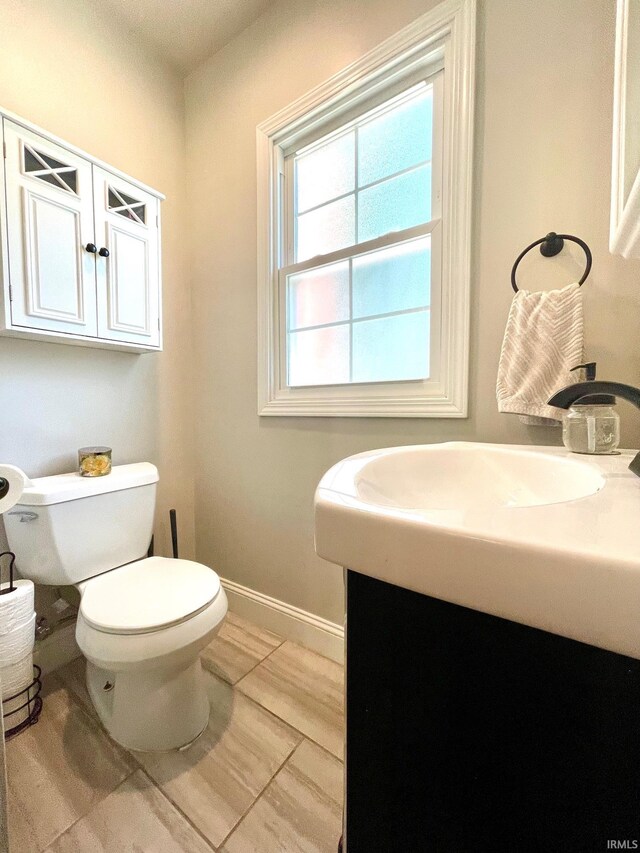 1304 Parkside Dr, Evansville, IN 47714 - bathroom featuring toilet, vanity, baseboards, and tile patterned flooring