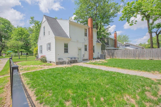 1304 Parkside Dr, Evansville, IN 47714 - rear view of property featuring a chimney, a shingled roof, and cooling unit