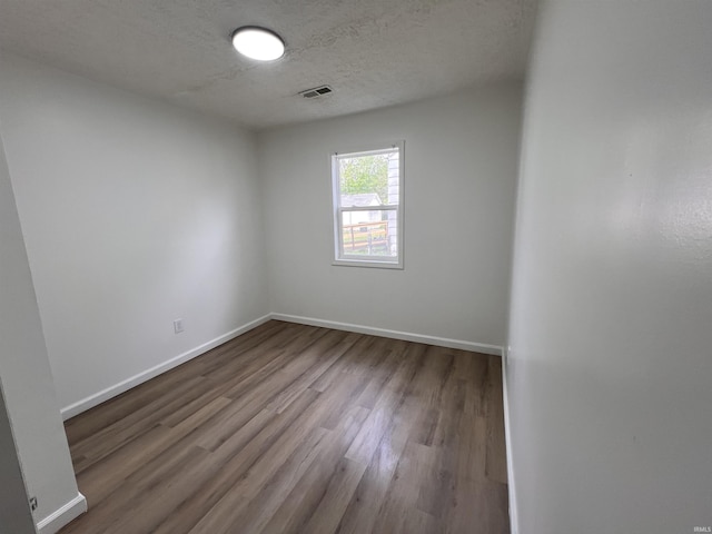 2108 W Memorial Dr, Muncie, IN 47302 - spare room with wood finished floors, baseboards, and a textured ceiling