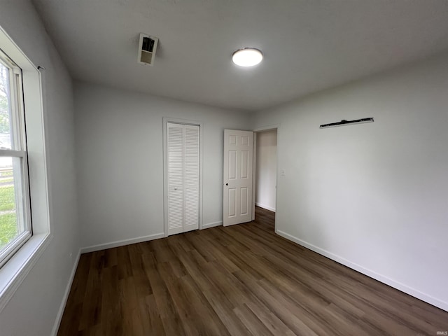2108 W Memorial Dr, Muncie, IN 47302 - unfurnished bedroom featuring wood finished floors, baseboards, and a closet