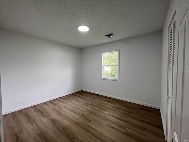 2108 W Memorial Dr, Muncie, IN 47302 - unfurnished bedroom with dark wood-style flooring and baseboards