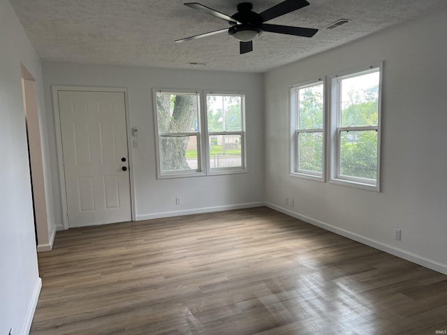 2108 W Memorial Dr, Muncie, IN 47302 - entrance foyer featuring a ceiling fan, wood finished floors, baseboards, and a textured ceiling